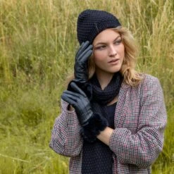 Women’s Touchscreen Three-Point Lined Leather Gloves With Faux Fur Cuffs 18 Women’s Touchscreen Three-Point Lined Leather Gloves With Faux Fur Cuffs -Dents woman wearing black leather gloves fauxfur cuff