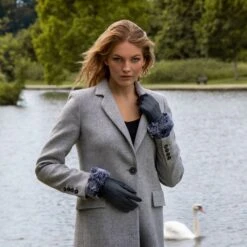 Women’s Touchscreen Three-Point Lined Leather Gloves With Faux Fur Cuffs 20 Women’s Touchscreen Three-Point Lined Leather Gloves With Faux Fur Cuffs -Dents woman wearing navy leather gloves faux fur cuff